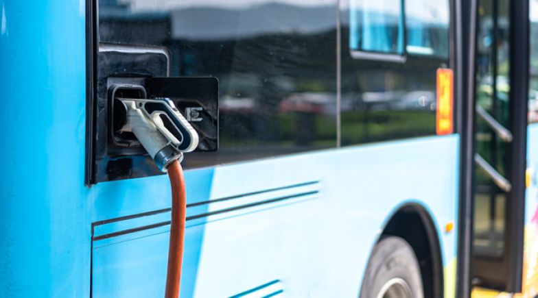 Electric bus stands at the charger